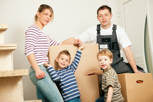 Professional movers loading household items into a van near Shepherds Bush