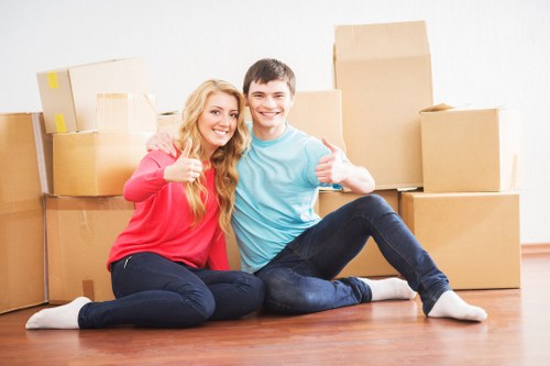 Mover wearing PPE while handling furniture during a safety-focused relocation