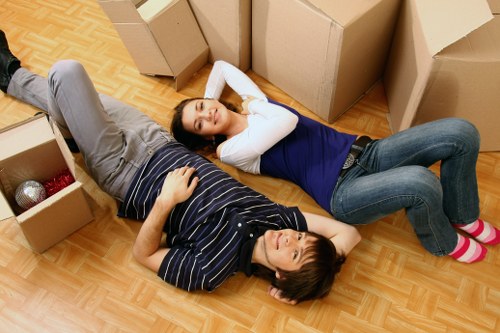 Packed moving boxes and furniture ready for transport in a West London home