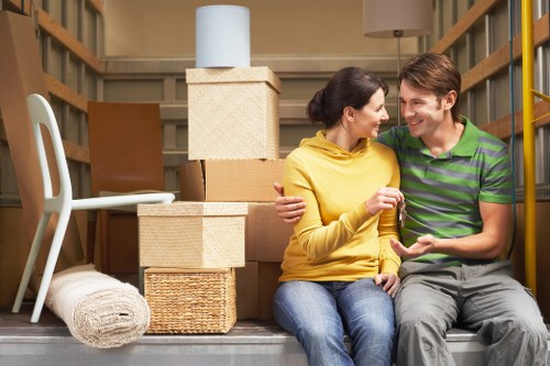 Packed moving boxes and furniture ready for transport in Shepherds Bush